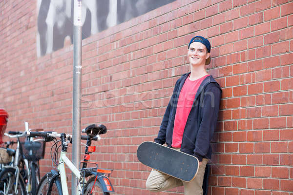 Handsome guy with skateboard Stock photo © adam121