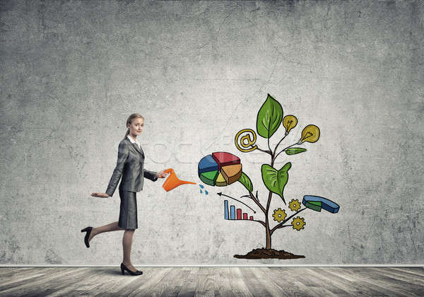 Young businesswoman in empty room watering drawn growth concept  Stock photo © adam121