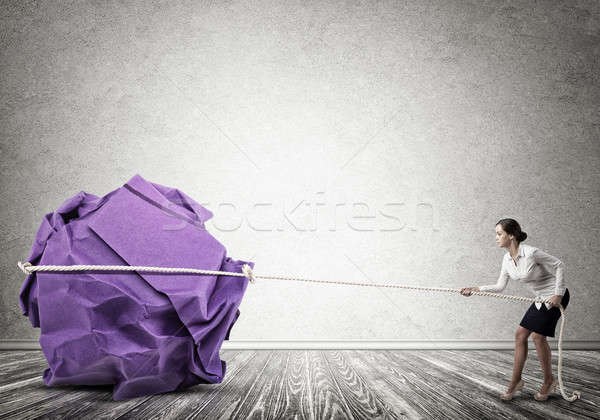Woman pulling with effort big crumpled ball of paper as creativi Stock photo © adam121