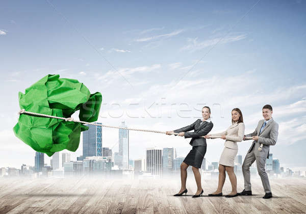 Young business people outdoors and huge paper ball as symbol of  Stock photo © adam121