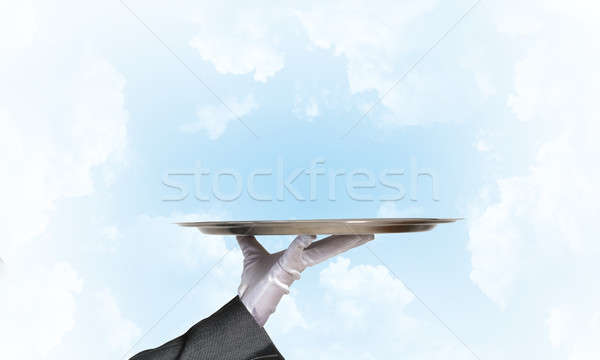 Waiter holding empty silver platter ready for product or item placement Stock photo © adam121