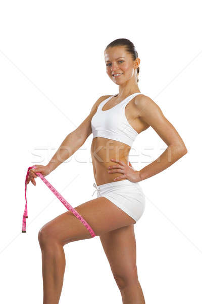 Stock photo: athletic woman measuring thigh