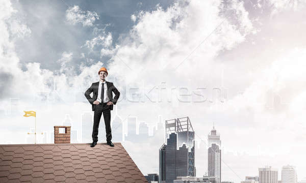 Engineer man standing on roof and looking away. Mixed media Stock photo © adam121