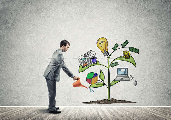 Young businessman in empty room watering drawn growth concept wi Stock photo © adam121