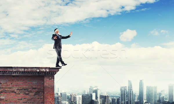 Danger and risk concept with businessman making step from edge Stock photo © adam121
