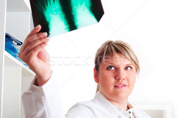 Female medic looking at x-rays Stock photo © adam121