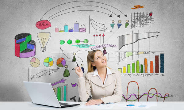 Stock photo: Thoughtful businesswoman sitting at table