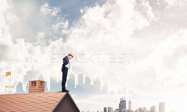 Engineer man standing on roof and looking down. Mixed media Stock photo © adam121