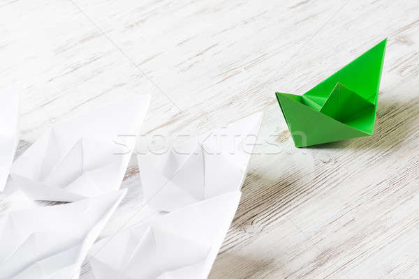 Business leadership concept with white and color paper boats on wooden table Stock photo © adam121