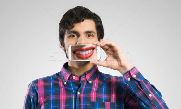 Hombre teléfono móvil joven sonrisa Foto stock © adam121