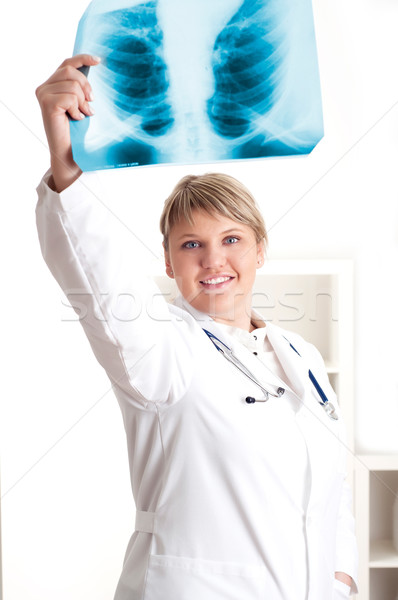 Female medic looking at x-rays Stock photo © adam121