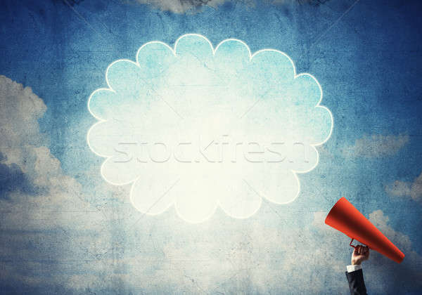 Hand of businesswoman holding red paper trumpet and speech cloud Stock photo © adam121
