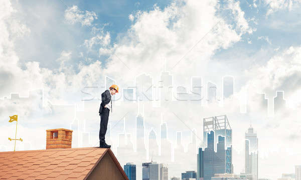 Engineer man standing on roof and looking down. Mixed media Stock photo © adam121