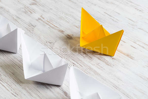 Business leadership concept with white and color paper boats on wooden table Stock photo © adam121