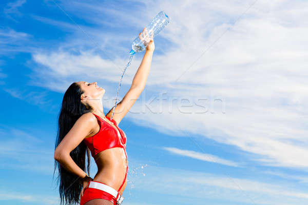 sport girl in red uniform with a bottle of water Stock photo © adam121