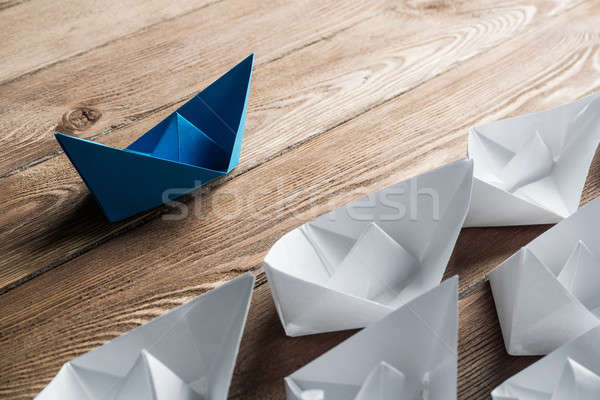 Business leadership concept with white and color paper boats on wooden table Stock photo © adam121