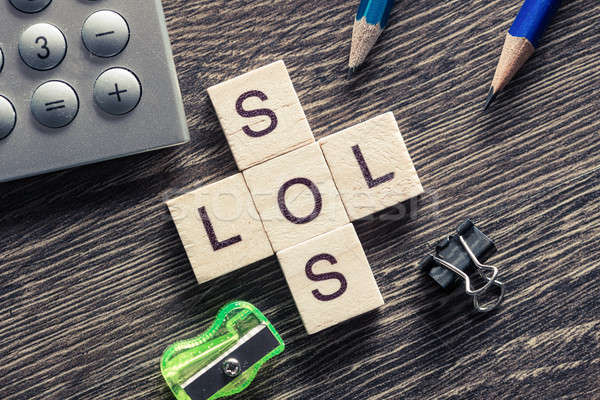 Words SOS and LOL on table made of wooden cubes elements Stock photo © adam121