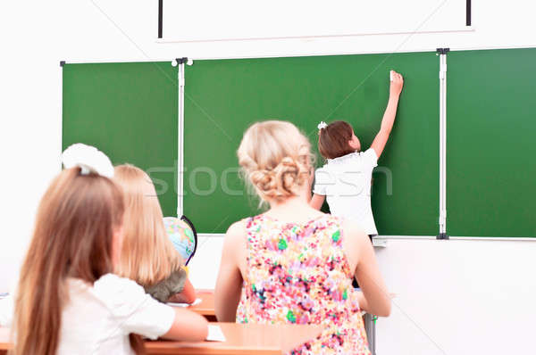 Uczennica tablicy klasy posiedzenia inny studentów Zdjęcia stock © adam121