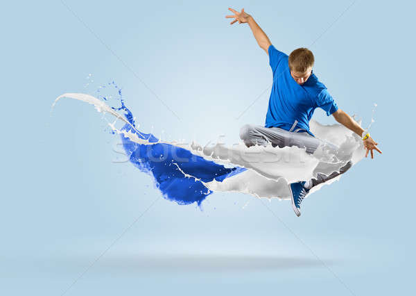 young male dancer jumping with splash of paint Stock photo © adam121