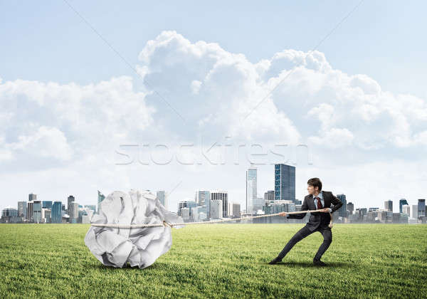 Man pulling with effort big crumpled ball of paper as creativity Stock photo © adam121