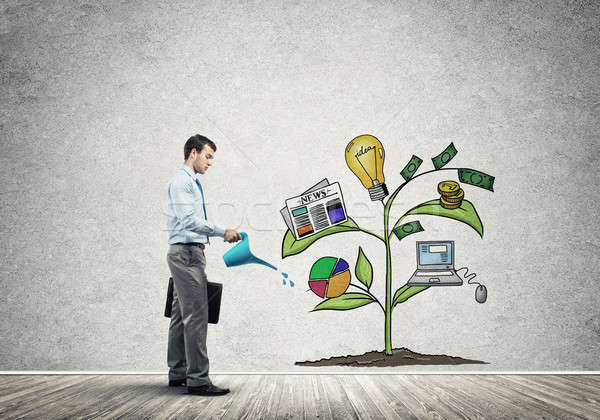 Young businessman in empty room watering drawn growth concept wi Stock photo © adam121