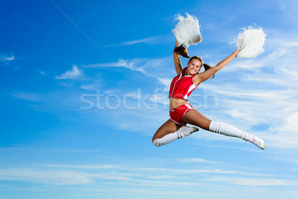 Jeunes cheerleader rouge costume sautant ciel bleu [[stock_photo]] © adam121