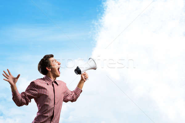 Portrait of a young man shouting using megaphone Stock photo © adam121