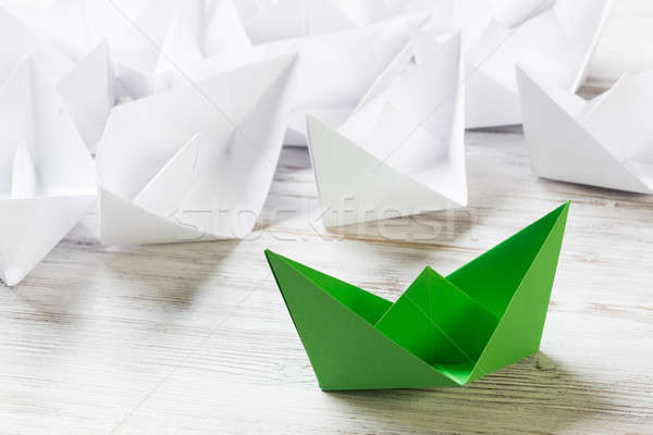 Business leadership concept with white and color paper boats on wooden table Stock photo © adam121