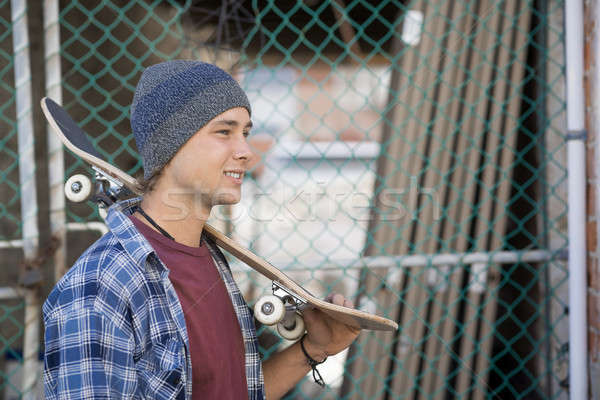 Handsome guy with skateboard Stock photo © adam121