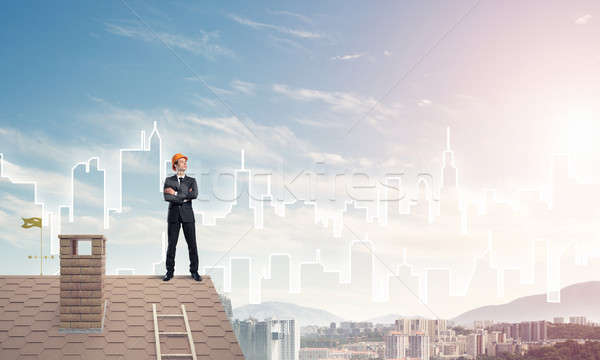 Engineer man standing on roof and looking away. Mixed media Stock photo © adam121