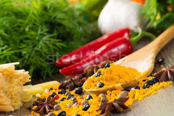 chilli, herbs and spices lie on a wooden surface Stock photo © adam121