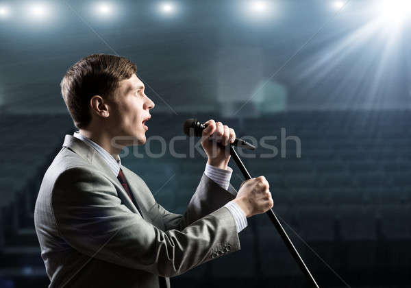 Businessman with microphone Stock photo © adam121