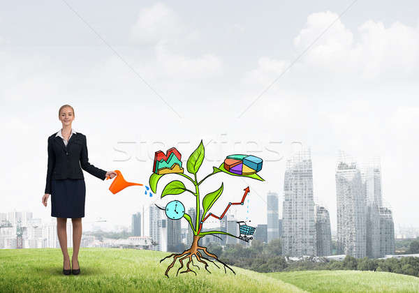 Young businesswoman outdoors watering drawn growth concept with can Stock photo © adam121