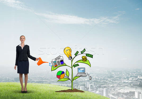 Young businesswoman outdoors watering drawn growth concept with can Stock photo © adam121