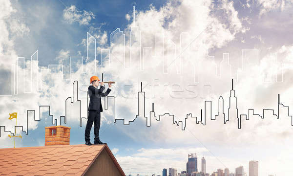 Engineer man standing on roof and looking in spyglass. Mixed med Stock photo © adam121