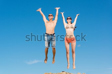 Stock photo: young couple jumping together