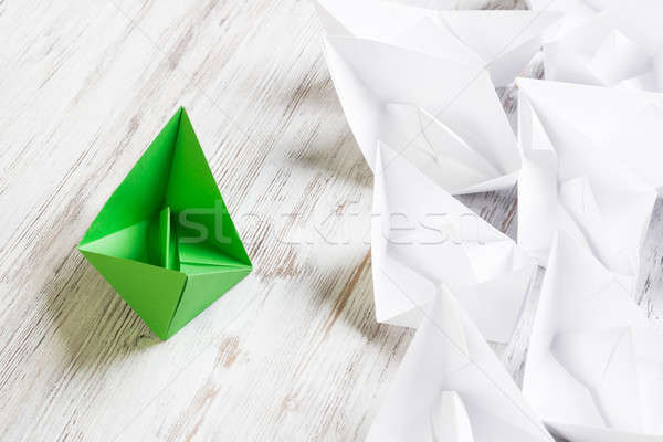 Business leadership concept with white and color paper boats on wooden table Stock photo © adam121