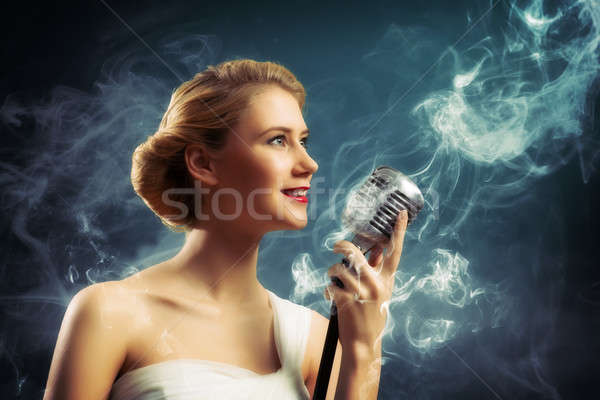 beautiful blonde woman singer with a microphone Stock photo © adam121