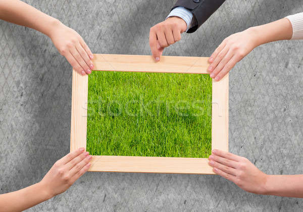 Grün menschlichen Hände halten Holzrahmen Stock foto © adam121