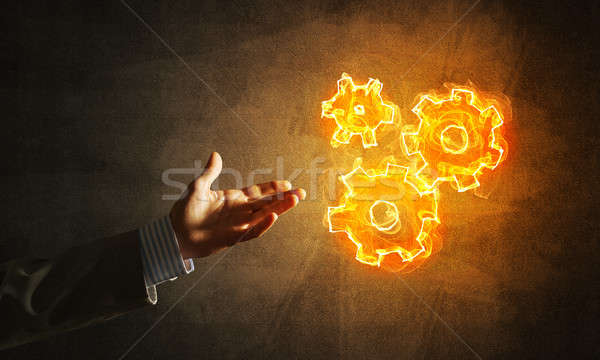 Concept of teamworking or organization presented by fire glowing cogwheels Stock photo © adam121