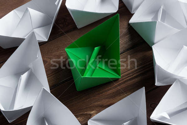 Business leadership concept with white and color paper boats on wooden table Stock photo © adam121