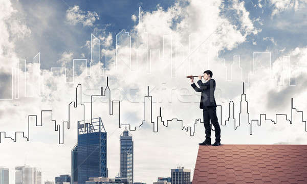 Engineer man standing on roof and looking in spyglass. Mixed med Stock photo © adam121