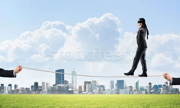 Stock photo: Business concept of risk support and assistance with man balancing on rope