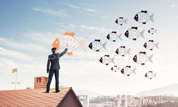 Businessman standing with back on house brick roof and drawing.  Stock photo © adam121