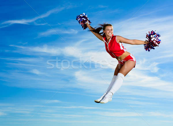 Jovem chefe de torcida vermelho traje saltando blue sky Foto stock © adam121