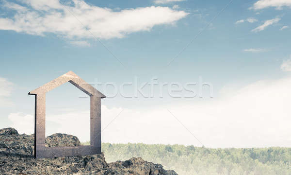 Conceptual image of concrete home sign on hill and natural lands Stock photo © adam121