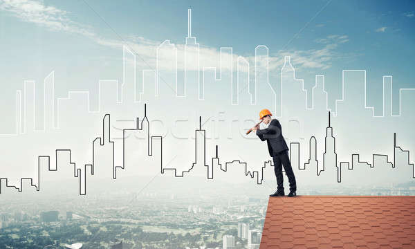 Engineer man standing on roof and looking in spyglass. Mixed med Stock photo © adam121