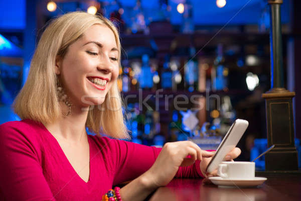 woman with a cup of coffee and cell phone Stock photo © adam121