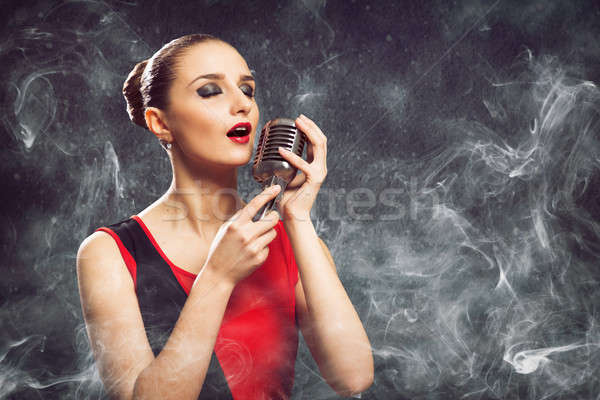 beautiful blonde woman singer with a microphone Stock photo © adam121