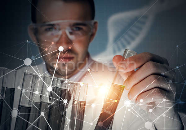 Stock photo: Portrait of concentrated male scientist working with reagents in laboratory